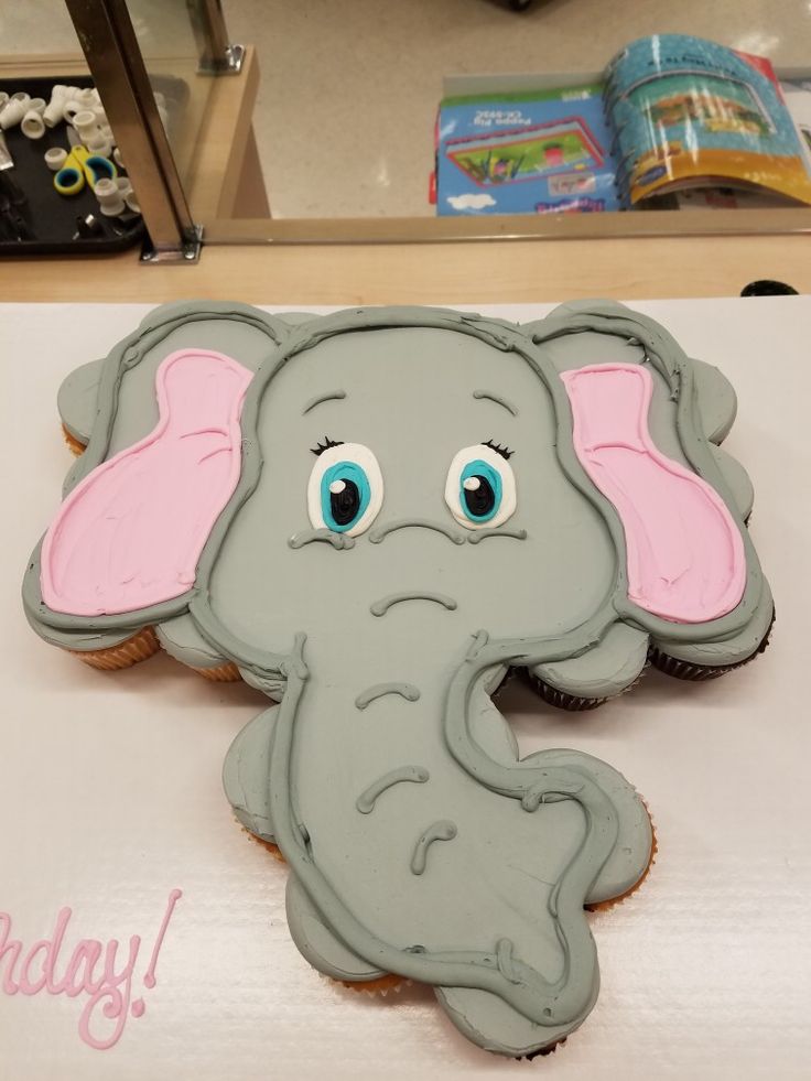 a cookie shaped like an elephant with blue eyes