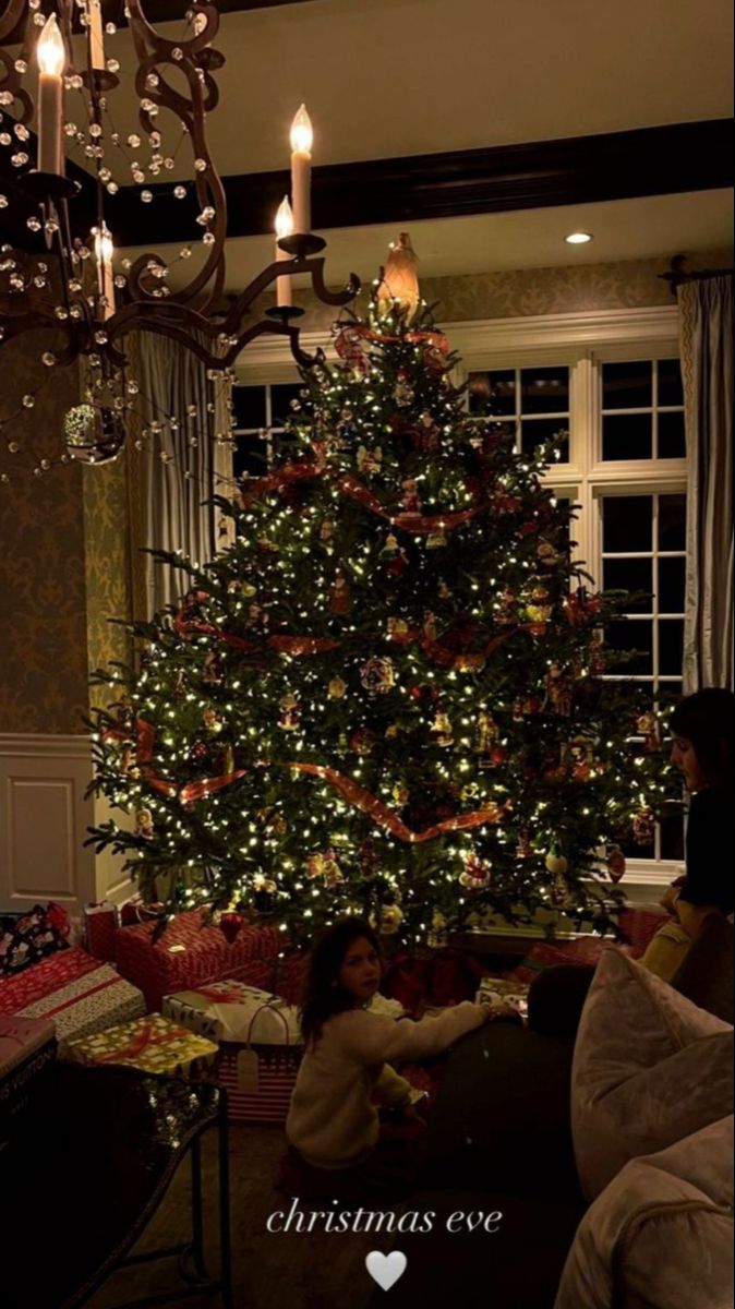 a christmas tree is lit up in the living room