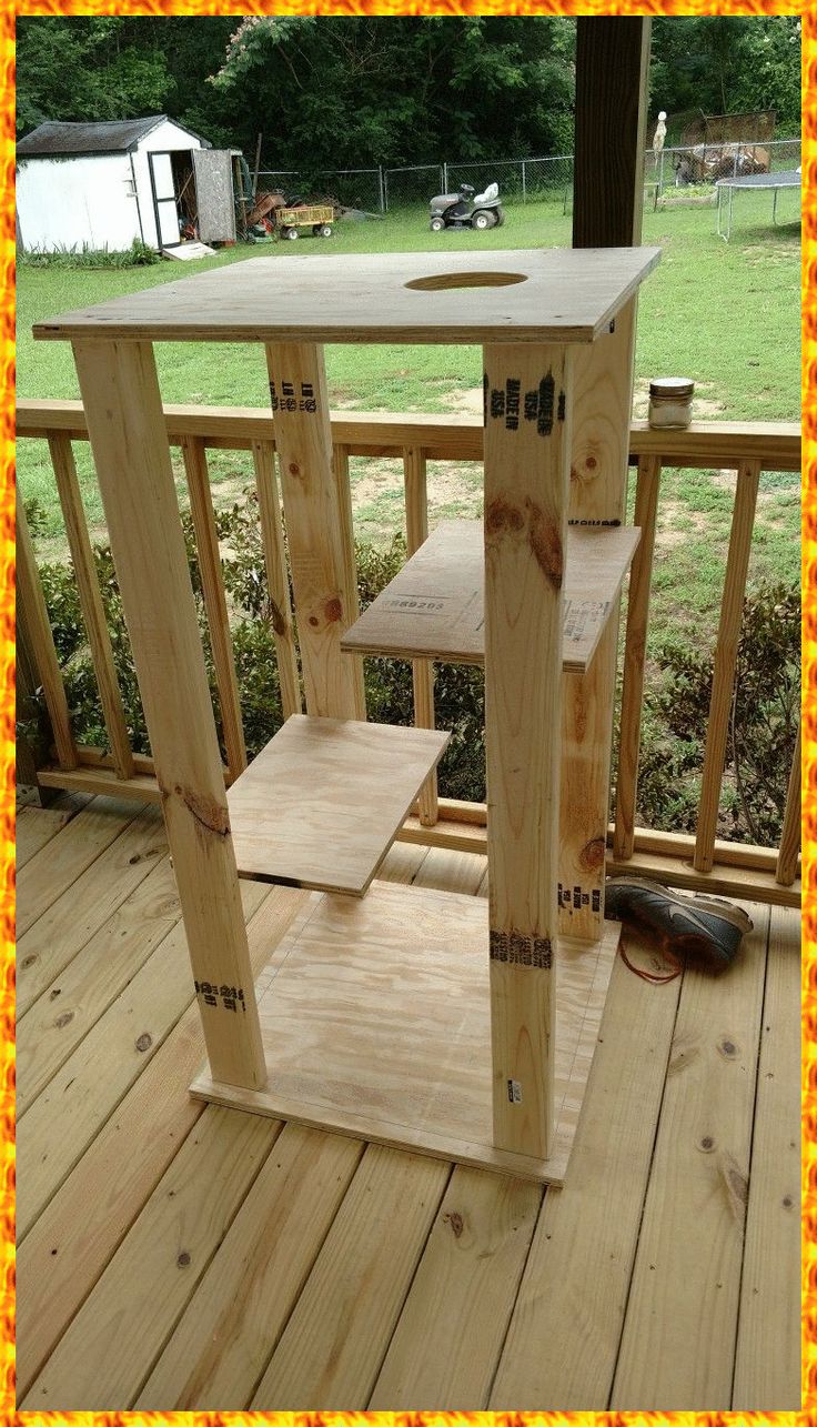 a wooden stand on a deck with some tools