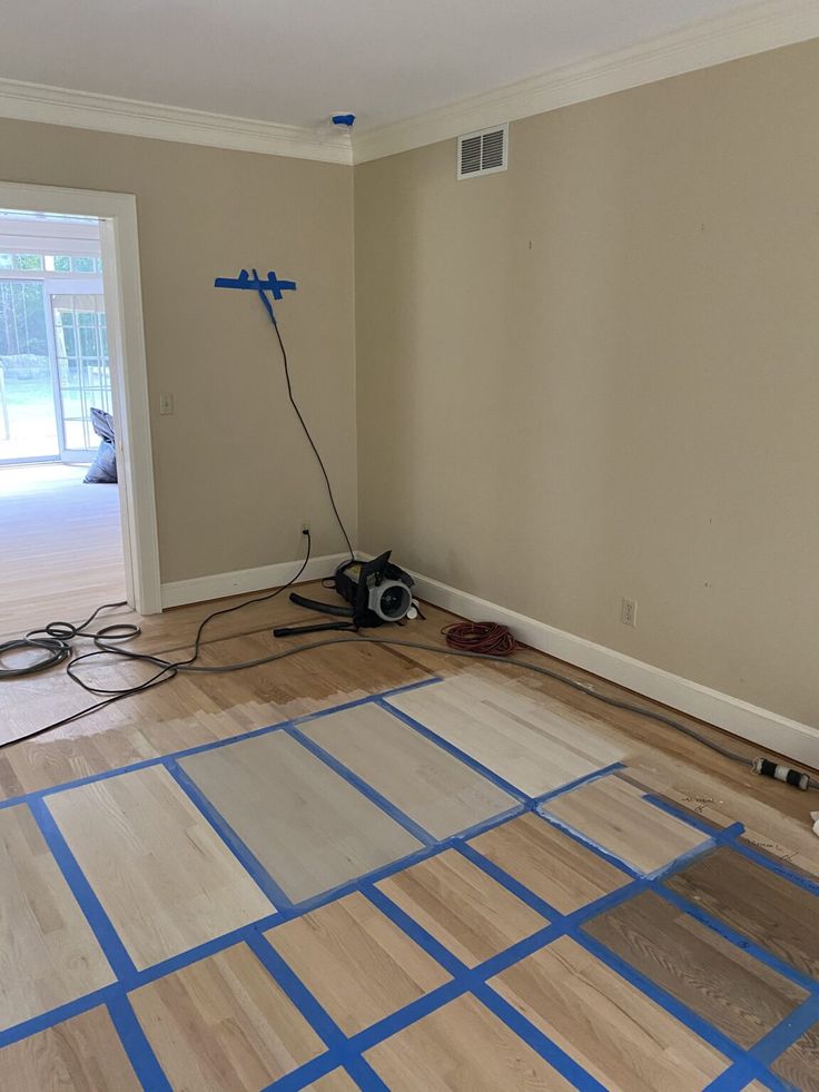 an empty room with hard wood flooring being installed