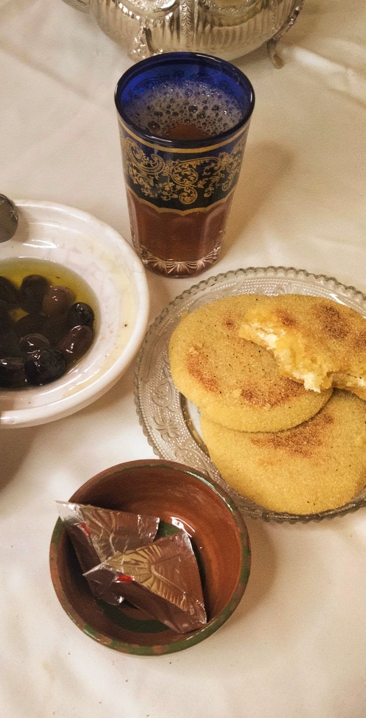 there are three desserts on the table and two cups with tea next to them