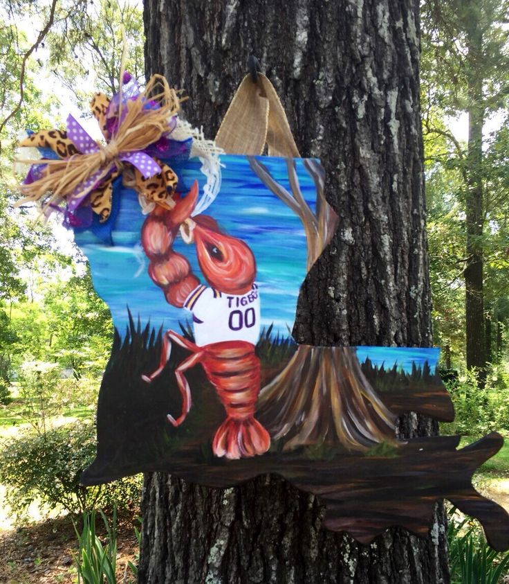 a wooden sign hanging from the side of a tree