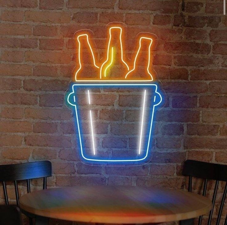 a table with two chairs and a neon sign on it