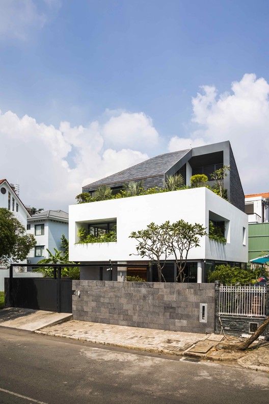 the house is white and has plants growing on it