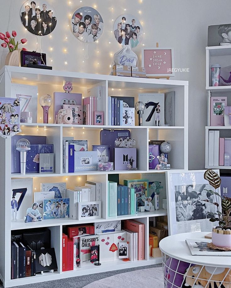 a white book shelf filled with lots of books on top of a carpeted floor