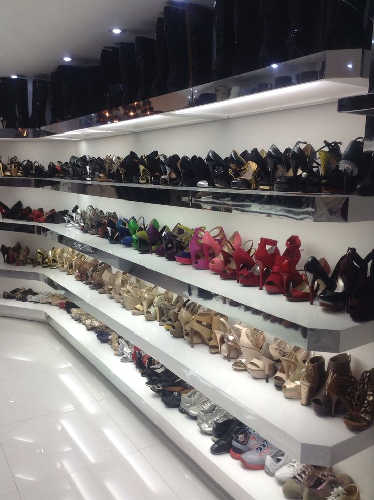 there are many pairs of shoes on the shelves