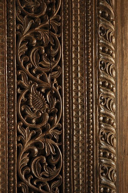 an intricately carved wooden door is shown