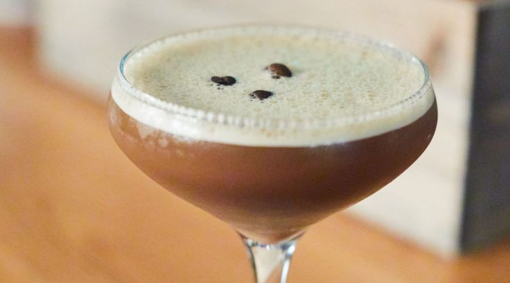 a close up of a drink in a glass on a table