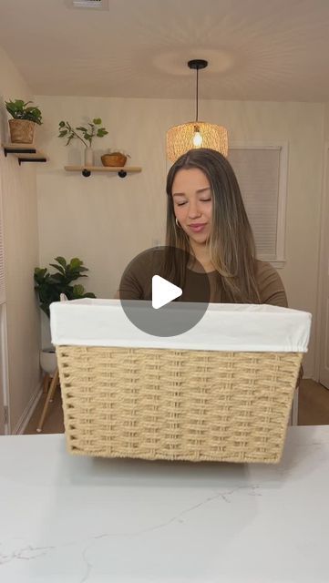 a woman sitting at a table with a wicker basket