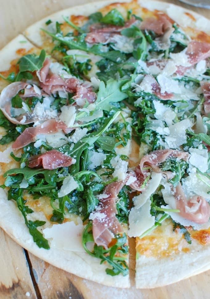 a close up of a pizza on a wooden table