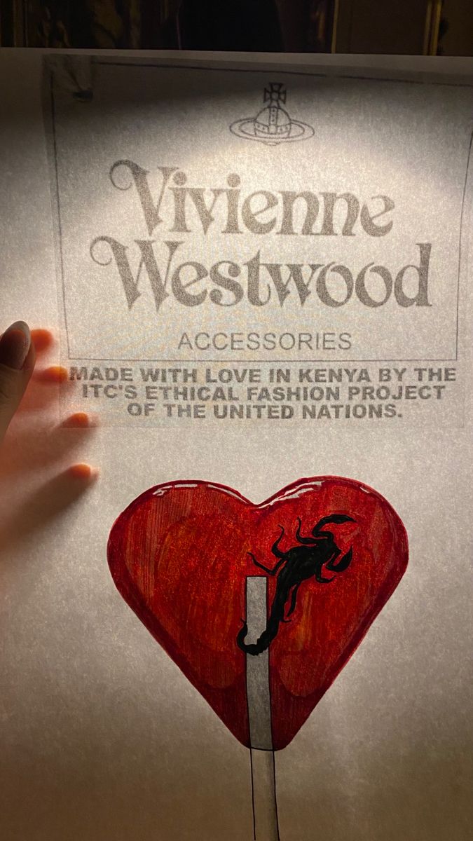 someone is holding up a poster with a heart and the words viviene westwood on it