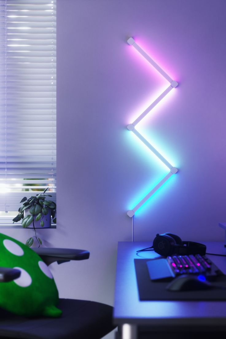 A gaming setup with Nanoleaf pillow on the chair and Nanoleaf Lines Squared on the wall Game Night Movie, Nanoleaf Lines, Led Light Art, Night Movie, Led Lighting Bedroom, Lighting Bedroom, Geometrical Design, Smart Lights, Led Light Fixtures