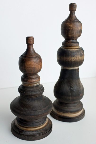 two wooden chess pieces sitting side by side