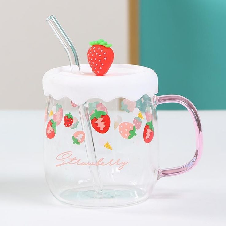 a glass mug with strawberries and strawberrys on it