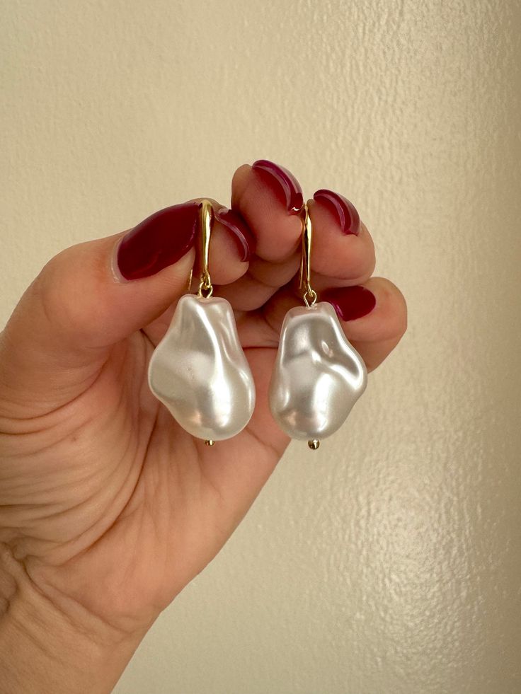 Collect your  compliments with my handmade Baroque pearl earrings. For my Chunky pearl hook earrings I used Faux baroque pearls and 14K gold plated materials. These pearl imitation earrings are light weight and hippo allergic. My acrylic pearl large earrings are suitable for women and men.  Look amazing with similar necklace. https://simplythepearl.etsy.com/listing/1671567841 Luxury Gold Baroque Pearl Earrings, Handmade Baroque Pearl Earrings For Party, Party Earrings In Pearl White With Baroque Pearls, Pearl White Baroque Pearl Earrings For Party, Party Pearl White Baroque Pearl Earrings, Trendy Pearl Earrings With Pearl Charm For Party, Trendy Party Pearl Earrings With Charm, Party Earrings With Pearl Charm And Baroque Pearl, Party Earrings With Baroque Pearl Charm