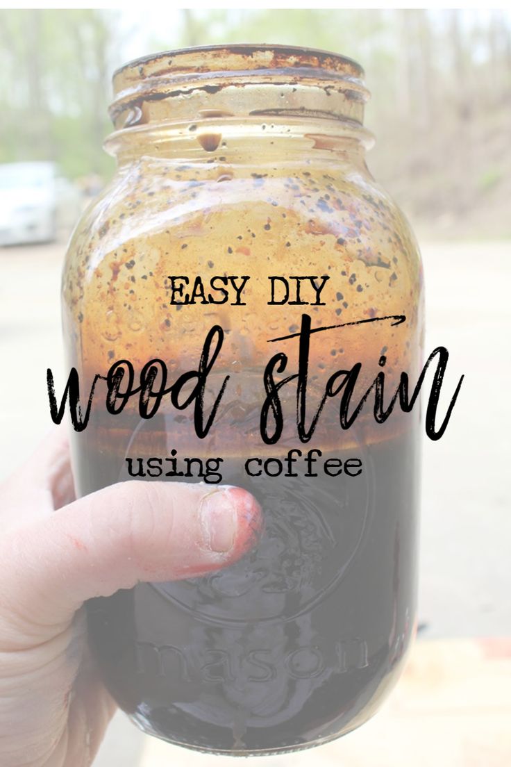 a hand holding a mason jar filled with wood stain and text overlay that reads easy diy wood stain using coffee