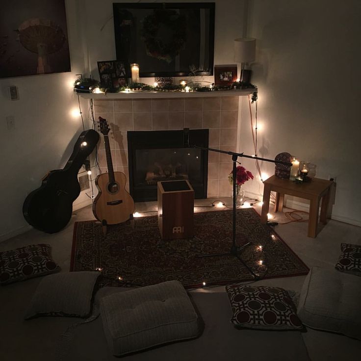 a living room filled with furniture and a fire place next to a fireplace covered in candles