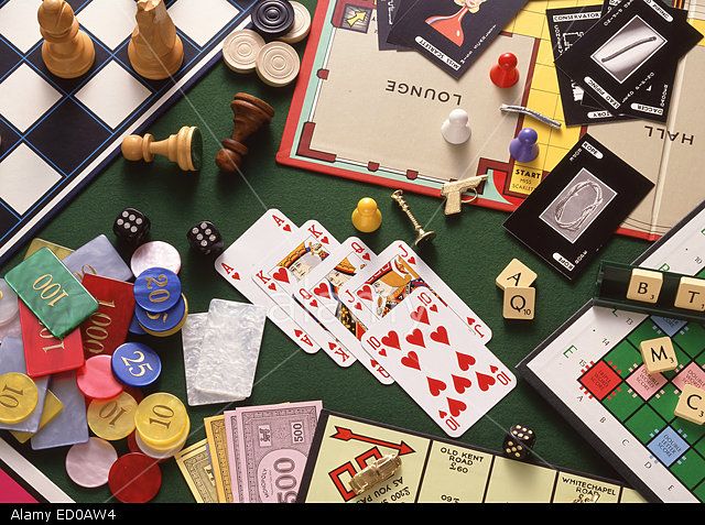 the board game is laid out on the table with its pieces and cards scattered around it