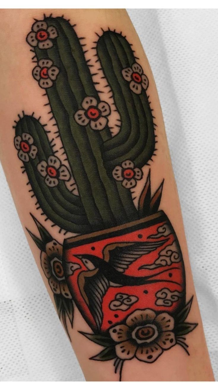 a cactus tattoo on the arm with red and black flowers in it's pot