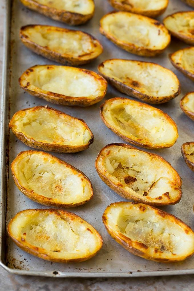 baked potato shells on a baking sheet ready to be cooked in the oven for dinner