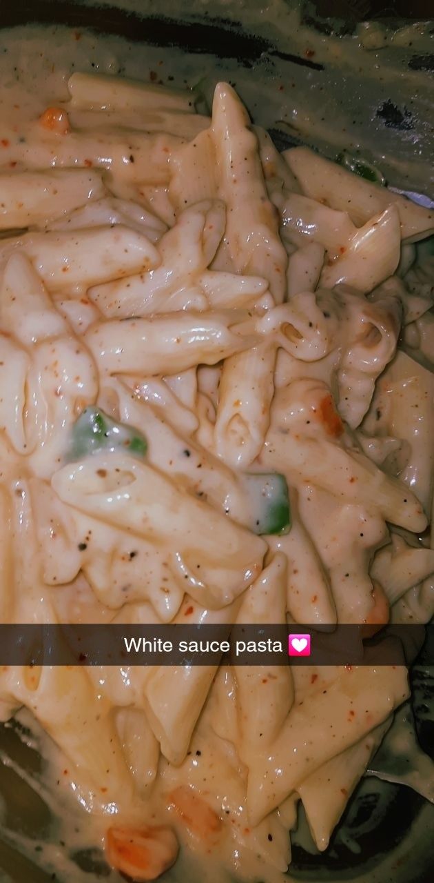 pasta with white sauce in a glass bowl