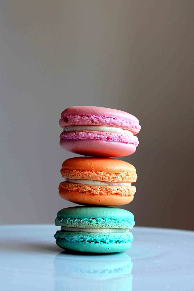 a stack of four macaroons sitting on top of each other in different colors