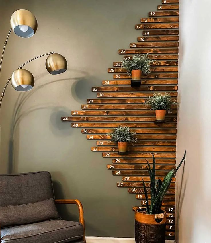 a living room filled with furniture next to a wall mounted planter on the side of a wooden staircase