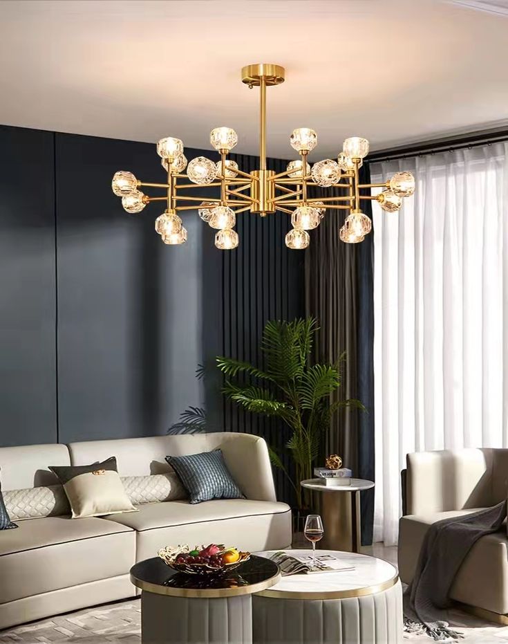 a living room with couches, chairs and a chandelier hanging from the ceiling