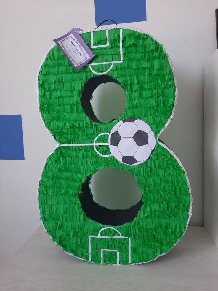 a paper mache shaped like a number with a soccer ball on it