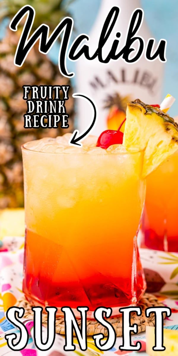 two glasses filled with fruity drink sitting on top of a table next to a pineapple