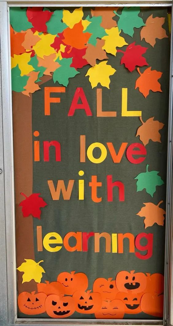 a bulletin board with pumpkins and leaves on it that says fall in love with learning