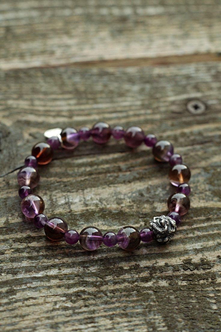 It is a perfect gift for your loved ones since it is a hand-made natural gemstone bracelet. It is a genuine Amethyst gemstone and handmade 925 sterling silver dragon head and Brand tag bracelet.  WE OFFER 100% NATURAL GEMSTONES CARVED FROM RAW STONES WHICH MAKES OUR PRODUCTS OF THE BEST QUALITY. We are small family jewelers located in Latvia, Europe, and we are proud that in our products, we use only genuine, natural, and unique gemstones. We spend so much time working with every single piece of gemstone and guarantee uniqueness and quality. About the Item Bracelet size: 19cm/7.5inch - We make/adjust the size you need. Amethyst beads size: 10mm and 6mm Material: Genuine unenhanced no dyed hand-carved from raw stone natural Amethyst. Amethyst Chakra: Crown Chakra. The Amethyst stone bracele Spiritual Sterling Silver Bracelet With Purple Gemstone, Sterling Silver Amethyst Bracelet Gift, Spiritual Purple Sterling Silver Bracelet, Spiritual Purple Gemstone Sterling Silver Bracelet, Faceted Amethyst Crystal Bracelet Gift, Rondelle Amethyst Bracelet With Natural Stones, Sterling Silver Crystal Bracelet With Round Beads For Healing, Spiritual Stretch Bracelet With Faceted Details As Gift, Spiritual Stretch Bracelet With Facets As Gift