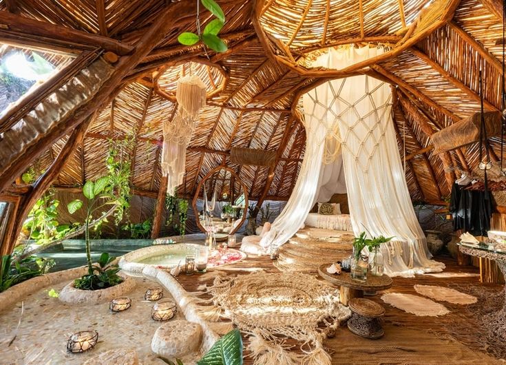 the inside of a hut with lots of plants and decorations on it's walls