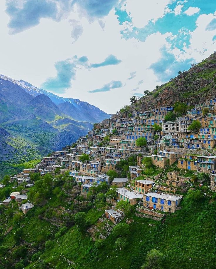 an aerial view of a village on the side of a mountain