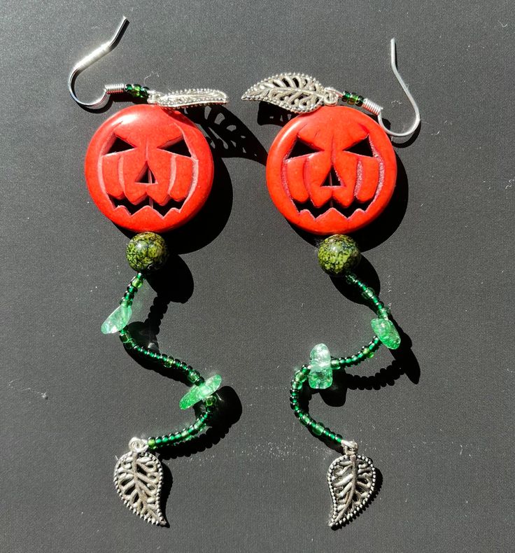 "These \"Straight From the Vine\" earrings are handmade from both bought and found materials. They are perfect for the autumnal/Halloween season (or year round if you enjoy wearing spooky jewelry any time)! I hope you consider buying, and if you do, I hope you love them! Dimensions and weight: 4 inches long, 1 inch wide, lightweight (0.2 oz/7 g). Standard shipping and returns." Halloween Plug Earrings As Gift, Whimsical Handmade Earrings For Halloween, Handmade Halloween Earrings Gift, Handmade Green Halloween Earrings, Whimsical Handmade Halloween Earrings, Spooky Handmade Earrings For Halloween, Handmade Witchy Earrings For Halloween, Spooky Handmade Halloween Earrings, Handmade Dangle Earrings For Halloween