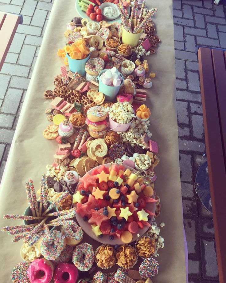 a long table filled with lots of different types of donuts