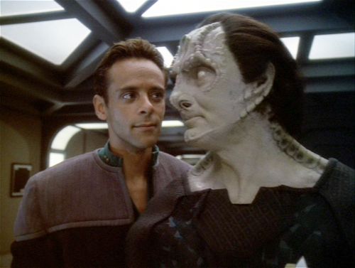 a man standing next to a woman in a star wars scene with her face painted white