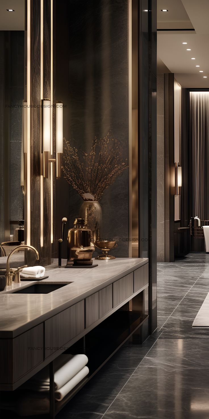 an elegant bathroom with marble counter tops and gold accents