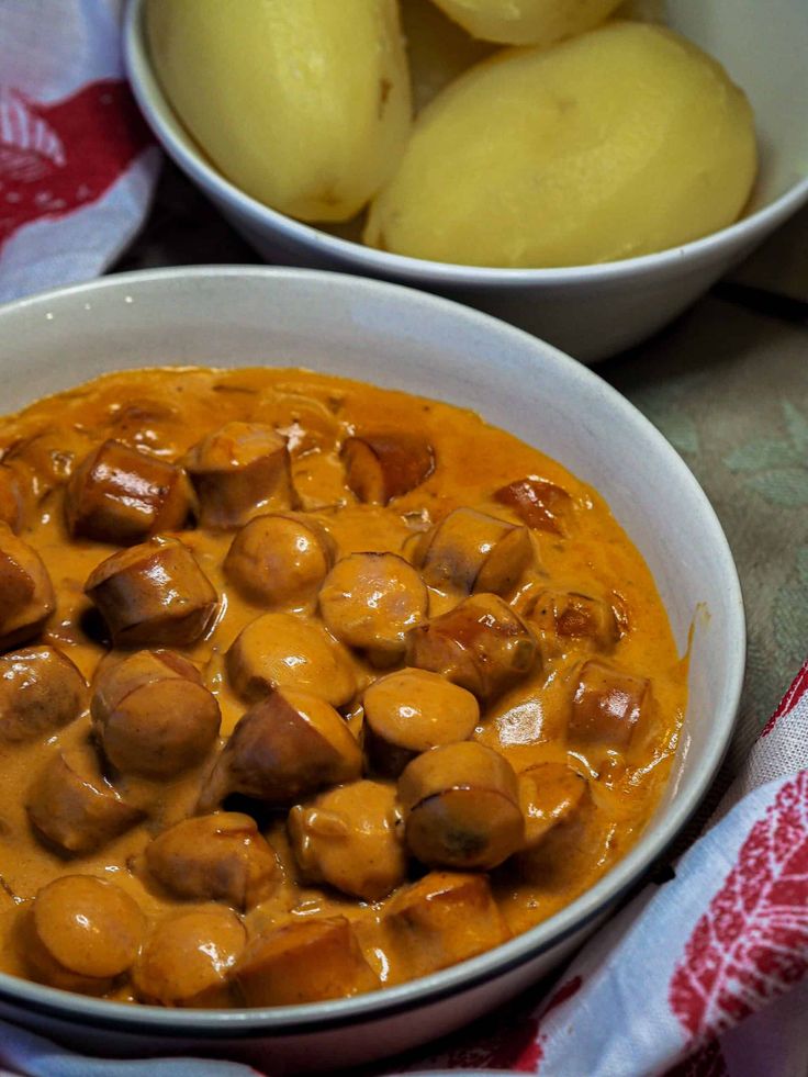 two bowls filled with food sitting on top of a table