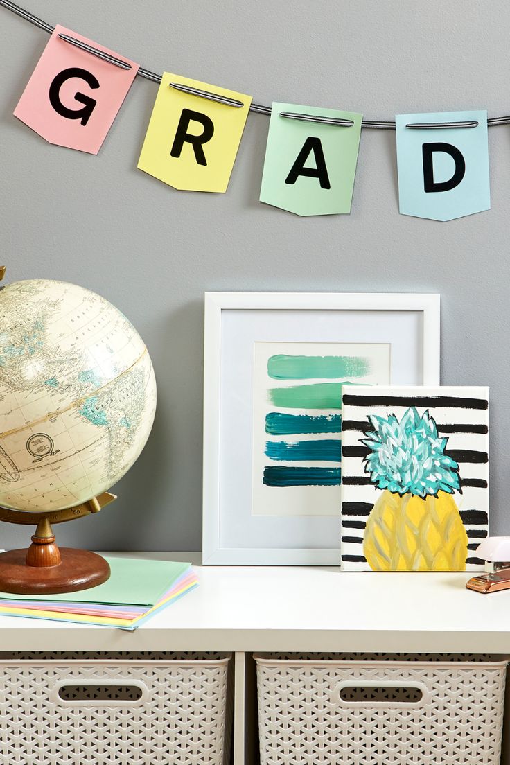 a white table topped with baskets and pictures next to a sign that reads grad