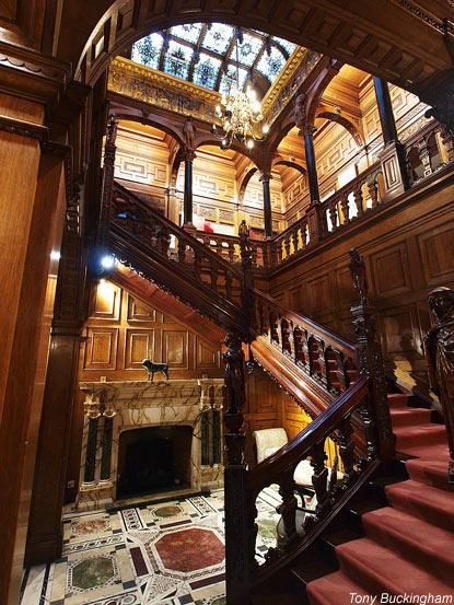 an ornate wooden staircase leading up to the second floor