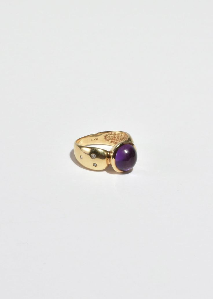 Stunning vintage gold ring with round amethyst cabochon and petite sapphire detail. Stamped 10k. Material: 10k gold, amethyst, sapphire. We recommend storing in a dry place and periodic polishing with a cloth. Gold Heirloom Amethyst Birthstone Ring, Heirloom Gold Birthstone Ring With Amethyst, Gold Amethyst Ring With Center Stone, Formal Amethyst Birthstone Ring With Round Stone, Heirloom Amethyst Birthstone Ring In Gold, Heirloom Amethyst Ring In Yellow Gold, Formal Amethyst Birthstone Ring, Yellow Gold Birthstone Ring With Amethyst Center Stone, Heirloom Amethyst Ring With Center Stone In 14k Gold