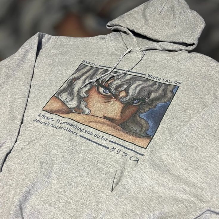 a gray sweatshirt with an image of a woman's face on the hoodie