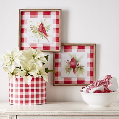 two red and white vases with flowers in them