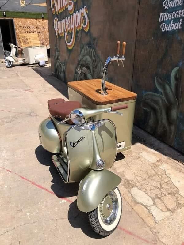 an old scooter is parked in front of a building