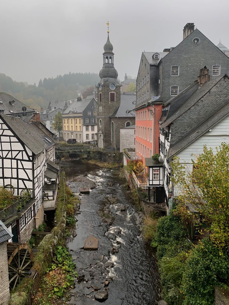 a river running through a small town surrounded by tall buildings