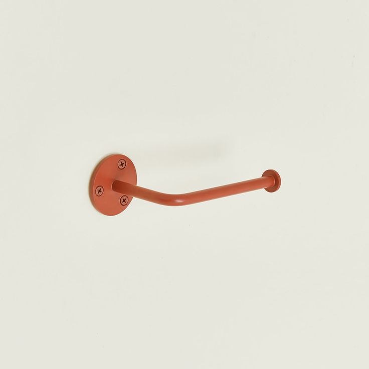 an orange handle on a white wall