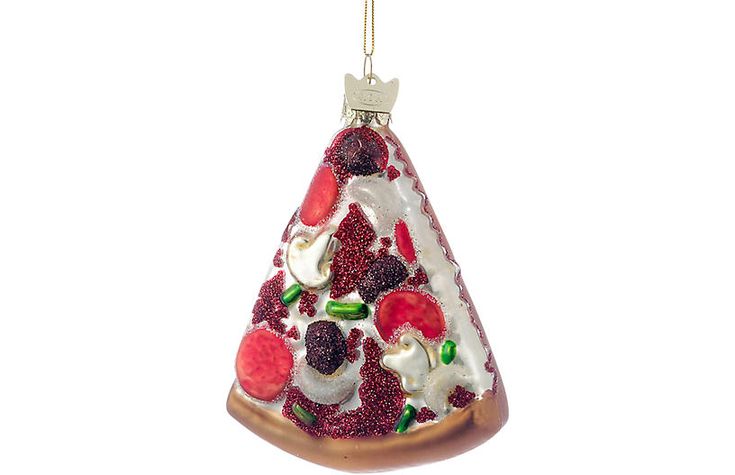 a glass christmas ornament shaped like a slice of pizza with toppings on it