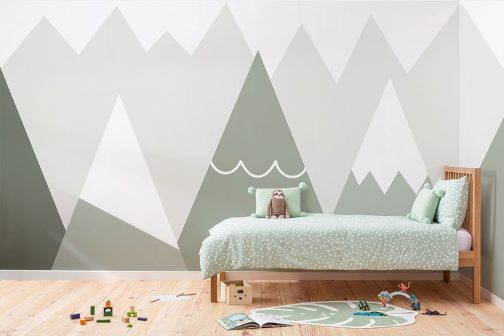 a child's bedroom with mountains painted on the wall