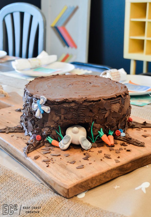 a chocolate cake sitting on top of a wooden cutting board